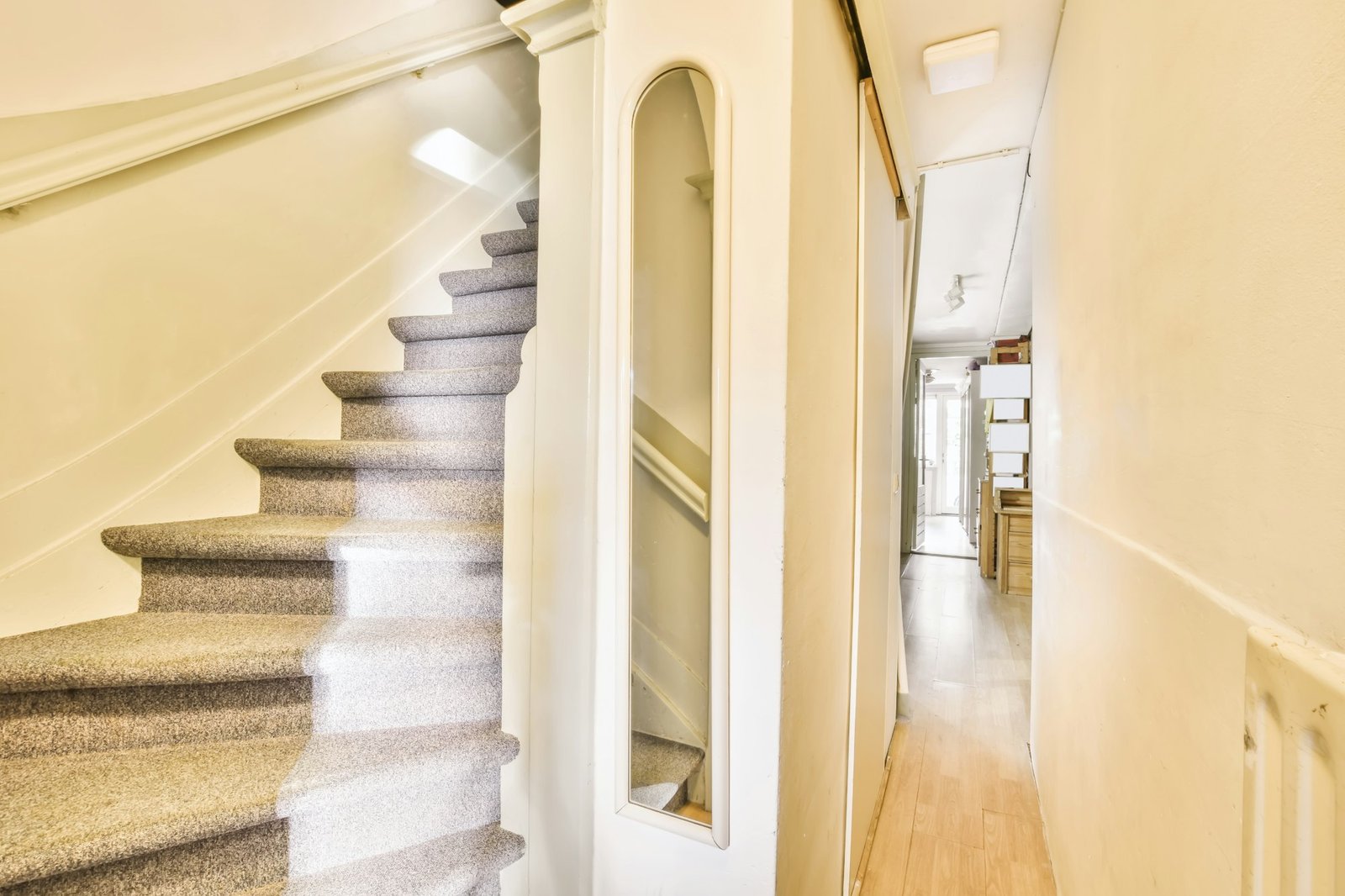 Nice staircase with gray carpet and white walls